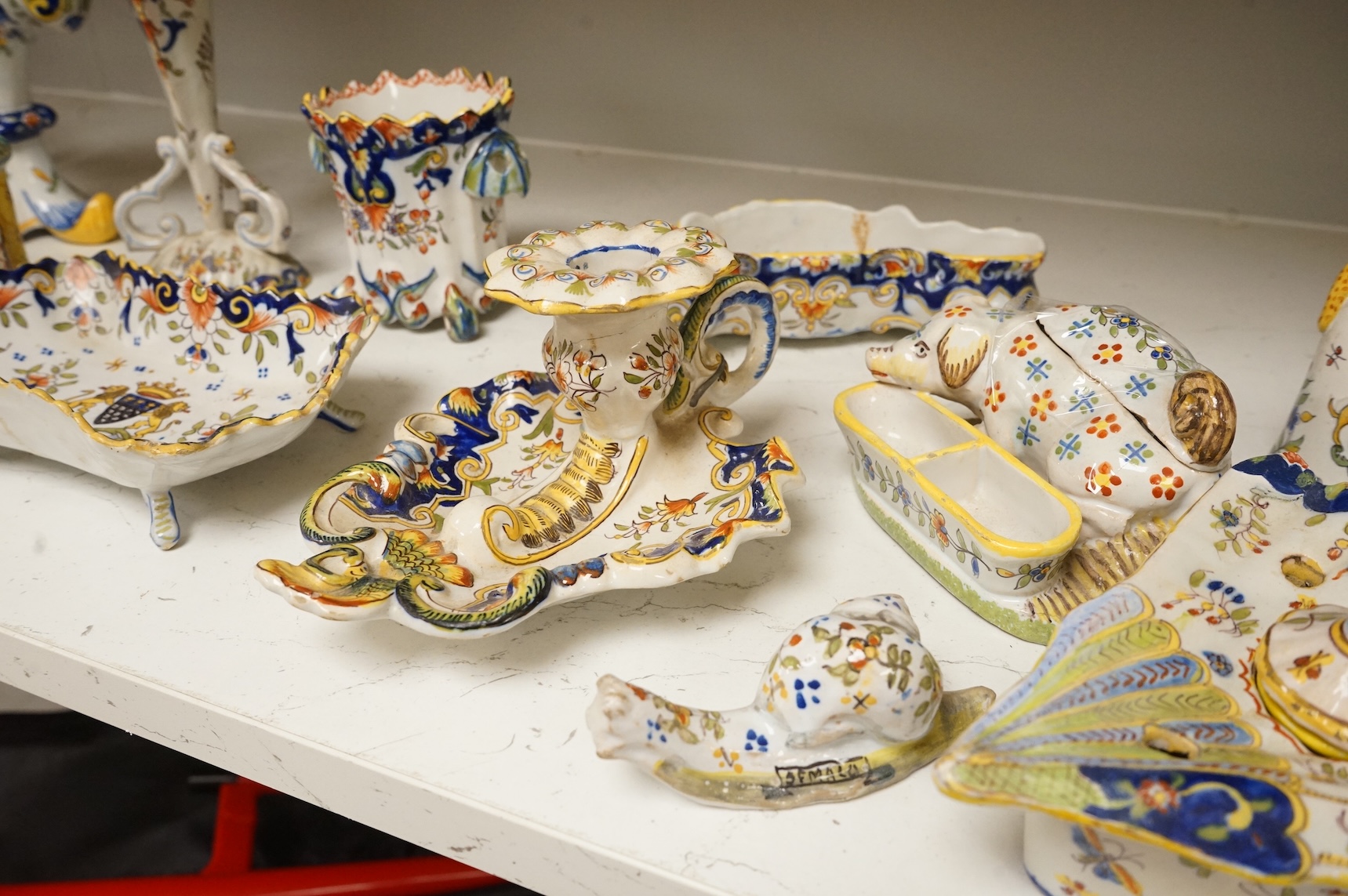 A group of French faience pottery to include spill vases, an ink well and dishes, largest 21cm high